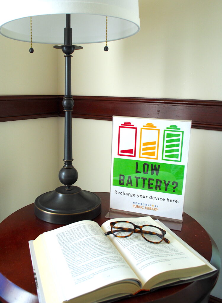 Tower room book with glasses near lamp